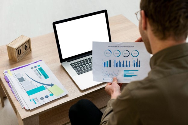 Profissional analisando relatórios gráficos e aplicando métodos quantitativos para embasar decisões estratégicas e otimizar resultados.